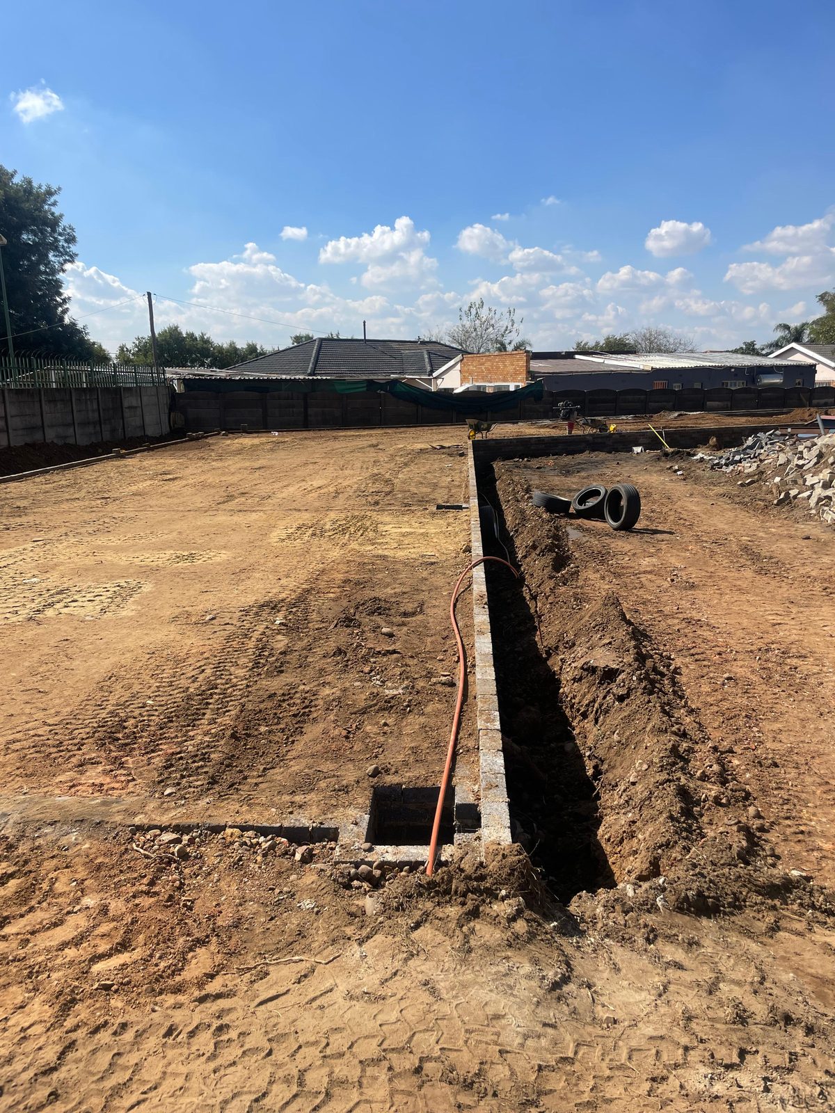 Building foundation excavation with reinforced footing trenches